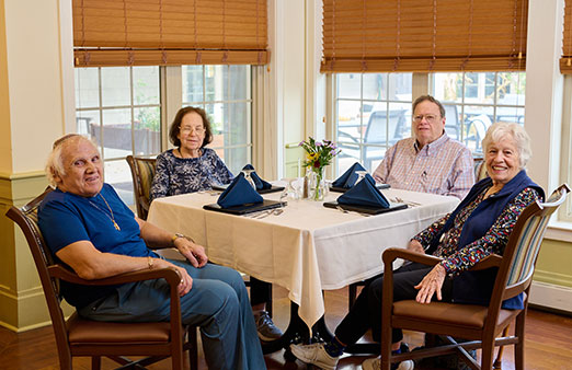 group of seniors sitting at a dining table.