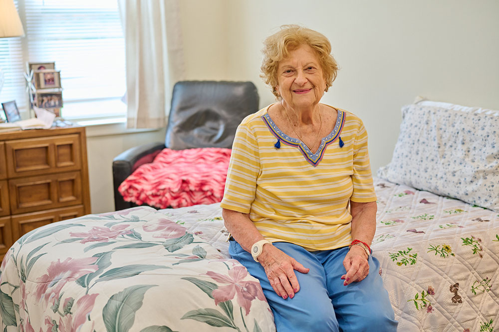 senior woman sitting on her bed